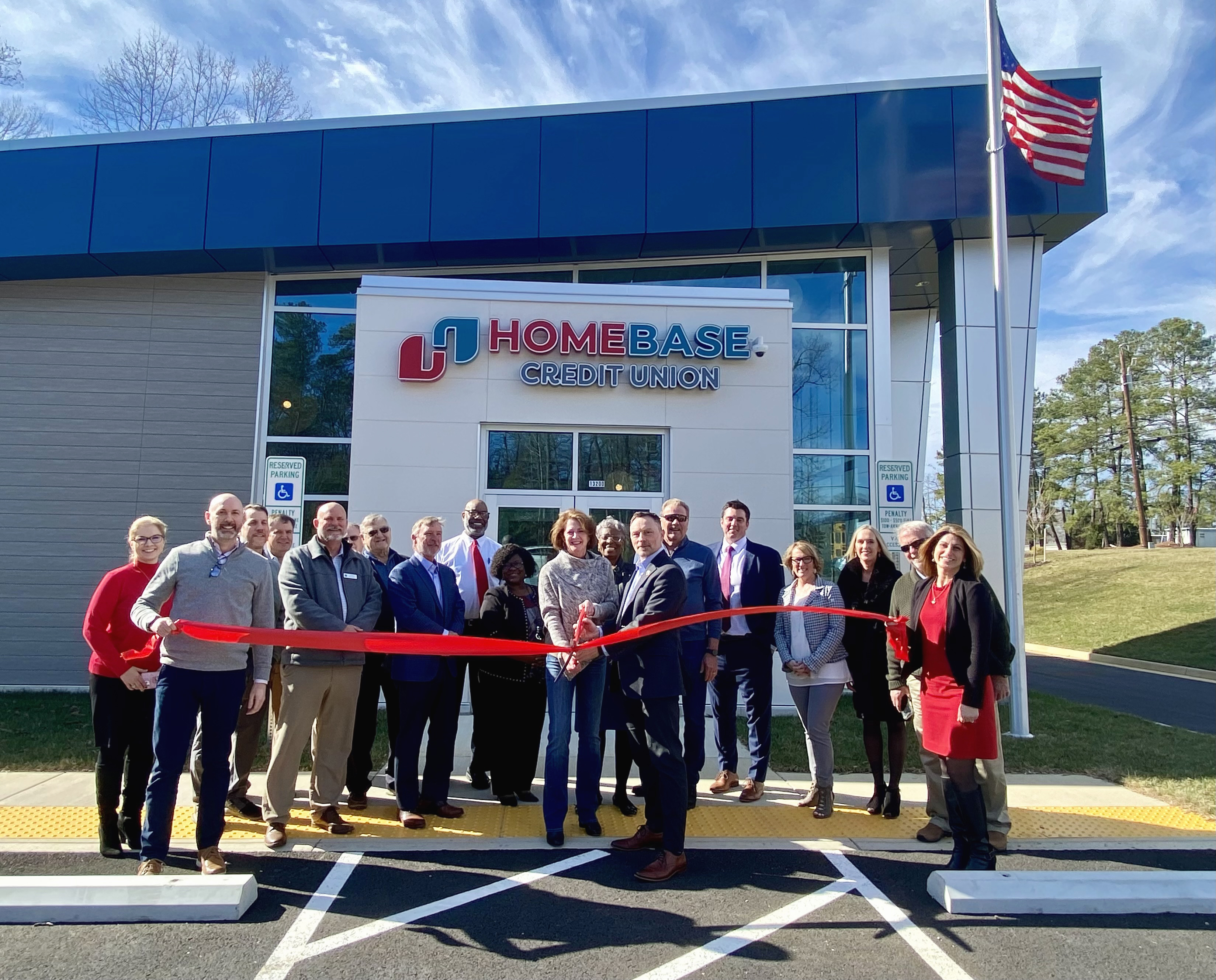 community group cutting ribbon in front of new branch